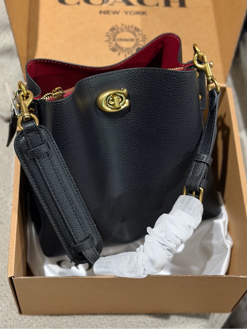 Black Pebbled Leather Bucket Bag with Red Interior and Gold Hardware